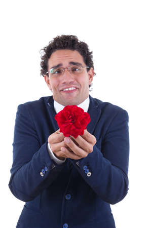 nerd in business suit with expression holding flowerの写真素材