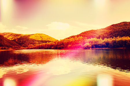 idyllic lake landscape with rays of sun