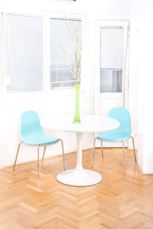 central table with flower in front of windows in dining room, home decor simplicity, clean and modern decorationの写真素材
