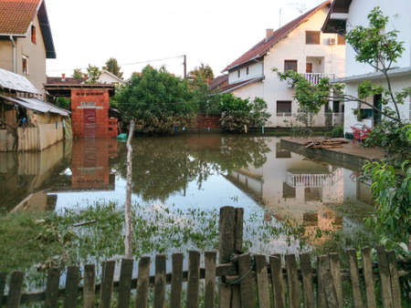 condition of house with a yard after floods, flood and disaster in town Obrenovac in Serbia, damaged houses and property, state or condition after terrible flood, destroyed and abandoned cityの写真素材