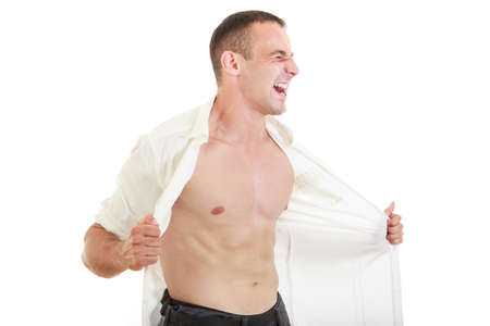Man ripping open his shirt showing chest and naked torso, Man tearing off his shirt yelling with strong expressionの写真素材