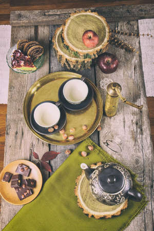 Retro kitchen table with tea set cookies and chocolate and coffee mill, Top view of traditional vintage kitchen tea pottery setの写真素材