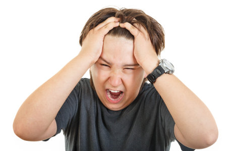 Shocked and scared young caucasian chubby kid or boy gesturing surprise  holding his hands at head,...