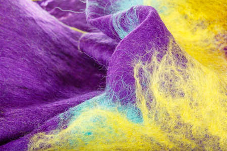 Cotton multicolored background of soft handmade farbic , Delicate purple and yellow woolen material of scarf in macro conceptの写真素材