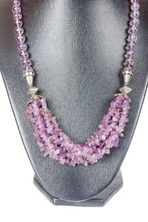 Beautiful stylish handmade pink woman bijouterie or female vintage fashion antique glamor colorful jewelry necklace on mannequin model showpiece doll isolated on white background. Studio shootの写真素材