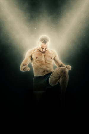 Full length portrait of boxer fighter in kick motion while striking in the airの写真素材