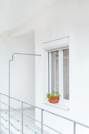 The Narrow Passage to the Front Porch. White Light Terrace on the First Floor of a Modern Design....