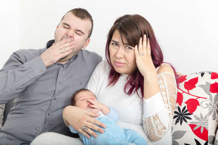 Young Couple Has None of Peace in Home Because Crying Small Few Weeks Old Baby. Man and Woman Having Insomnia and Lack of Sleep.の写真素材
