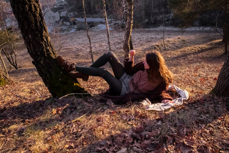 red-haired girl resting and enjoying the setting sun