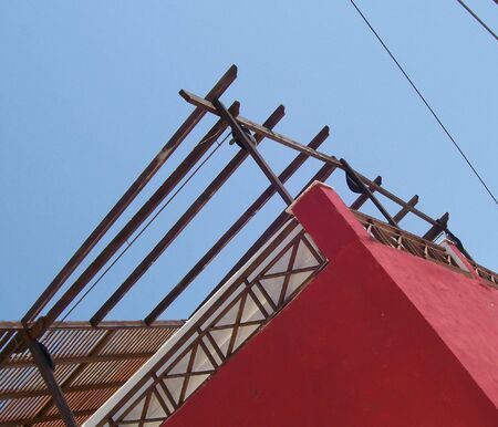 an image of a colourful red house standing in the bright sunの写真素材