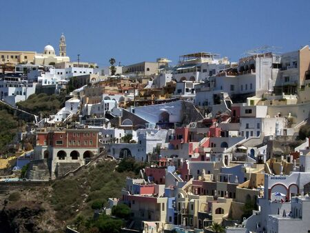 image of Fira mountainside houses beautifully decorated with bright coloursの写真素材
