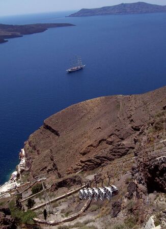 the cableway to get down the mountain from the village of Fira, where swimming and cruiseships awaitsの写真素材