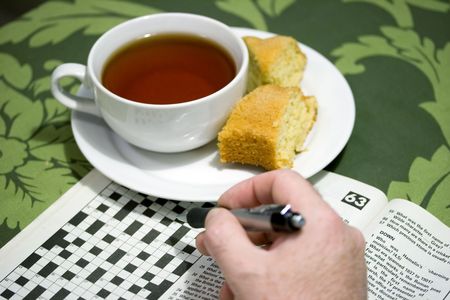 morning cup of tea with crossword puzzleの写真素材