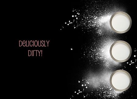 Cans of white paint with paint splashesの写真素材
