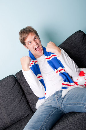 crazy young man supporting his football teamの写真素材