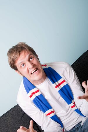 crazy young man supporting his football teamの写真素材
