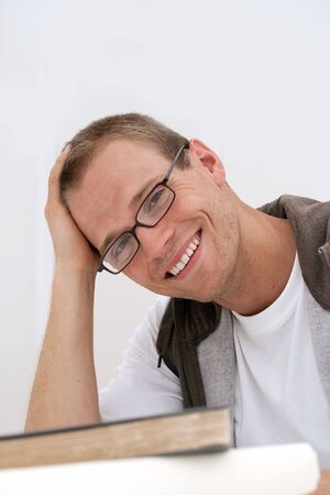 Young male student smiling wearing glassesの写真素材