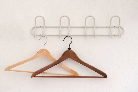 couple of wooden coathangers on a wallの写真素材