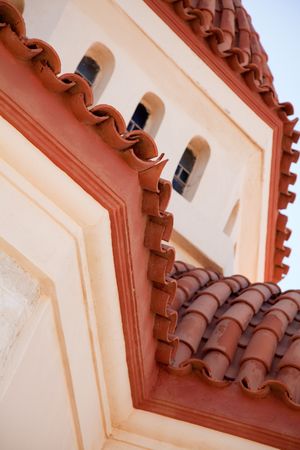 Architectural detail of a typical brick coloured cretan church roof. Crete, Greece.の写真素材