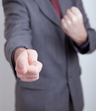 man in suit making a threatening gesture. Very shallow DOF - focus on pointing fingerの写真素材