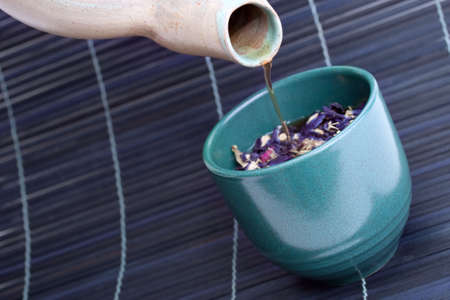 cup of herbal tea with rose petalsの写真素材