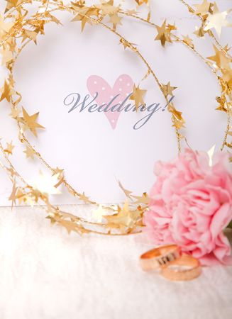 Wedding invitation with gold ribbon and ringsの写真素材