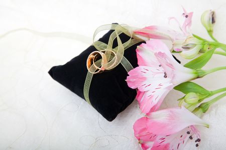 Wedding still life with rings, flowers and a felt cushionの写真素材
