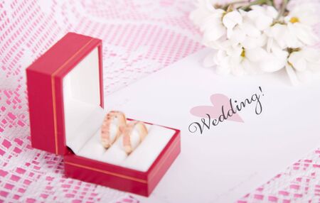 Wedding still life with rings in the box, flowers & invitation card.の写真素材