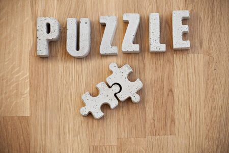 Puzzle pieces and concrete letters. の写真素材