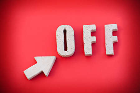 Image showing an arrow pointing at an OFF sign.の写真素材