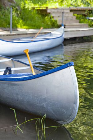 Image of empty canoes by the river.の写真素材
