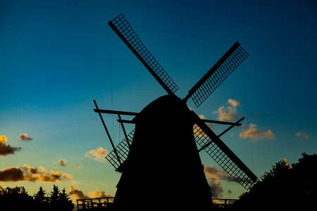 Traditional old windmill. Silhouette at sunset.の写真素材