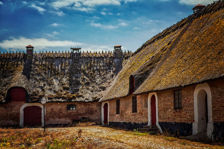 Image of an old traditional cottage farm with thatched roof. Scania, Sweden.