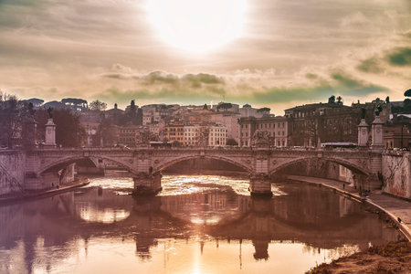 Image of sunset in Rome, Italy, by one of its bridges.の写真素材