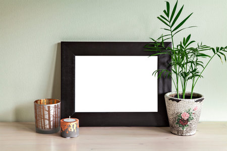 Image of frame mockup scene with plant and candle holders.