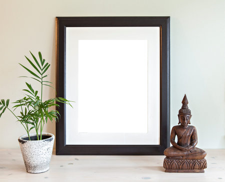 Image of a mockup scene with wooden frame, plant and buddha statue.