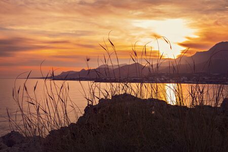 Image of colorful sunset landscape on Crete, Greece. The village of Mkrigialos in the background.の写真素材