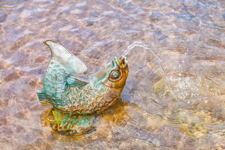 Image of a decorative fish in a fountain.の写真素材