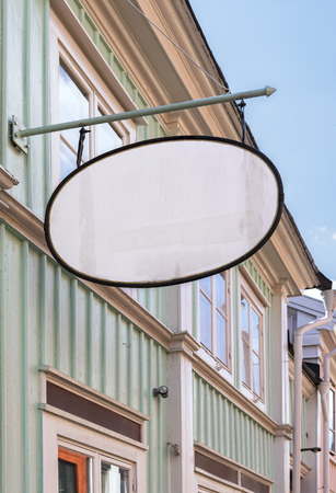 Image of vintage shop sign hanging on wooden building.の写真素材
