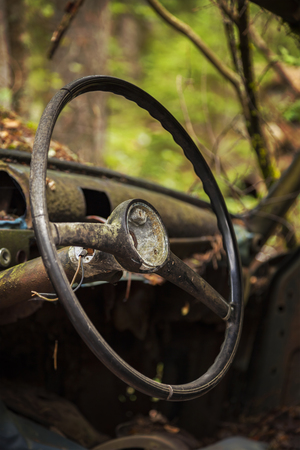 Close up of the steering wheel of an abandoned rusty old car.の写真素材