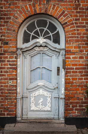 Image of vintage door in old brick building. Copenhagen, Denmark.  の写真素材