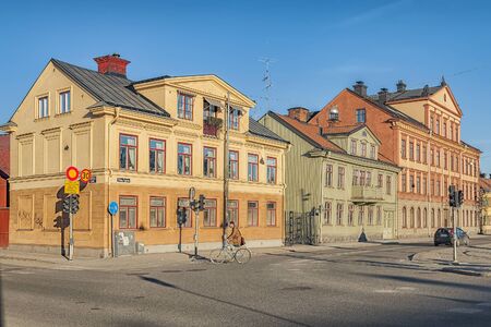 UPPSALA, SWEDEN - APRIL 05, 2013. Sparse traffic on a street with historic buildings.のeditorial素材