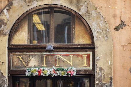 Image of old building with "wine" sign over window. Rome, Italy.の写真素材