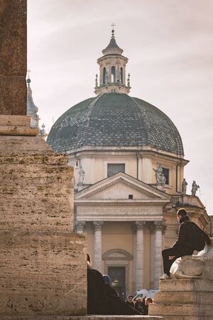 ROME, ITALY - JANUARY 08, 2014. People by the obelisk on Piazza del Popolo, looking on to the church of Santa Maria dei Miracoli.のeditorial素材