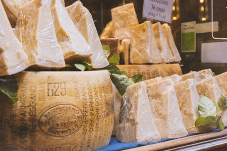 BOLOGNA, ITALY - FEBRUARY 08, 2017. Shop window display of local cheese shop selling Parmigiano Reggiano.のeditorial素材