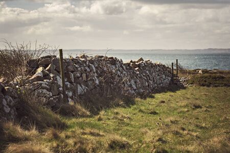 Natural stone wall built by the seaside. の写真素材