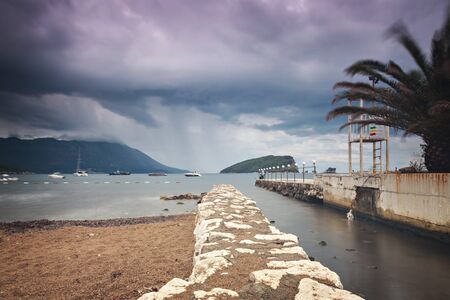 Jetty at beach on moody day. Budva, Montenegro.の写真素材