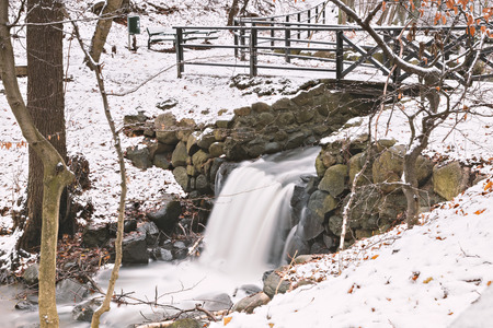 Small waterfall in snowy forest. Helsingborg, Sweden. の写真素材