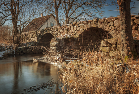 Old  stone bridge over river in the countryside. の写真素材