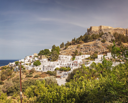 Village of Lindos with fortress on hilltop. Rhodes, Greece.のeditorial素材